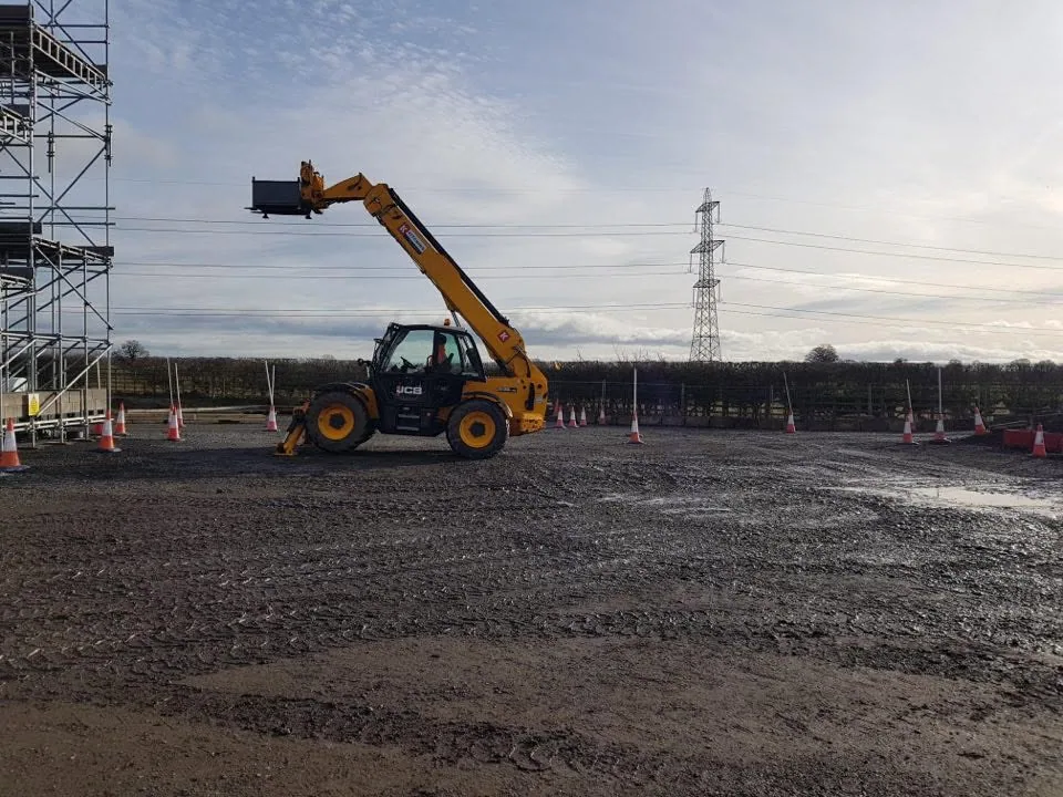 JCB telescopic handler with its boom raised